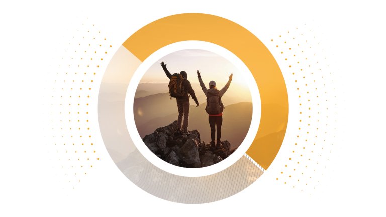 Two hikers with backpacks celebrating on a mountain peak at sunrise, symbolizing success and resilience in navigating freight challenges.