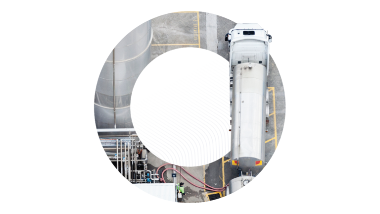 An aerial top-down view of a chemical tanker truck loading at an industrial terminal, framed within a circular graphic, representing efficiency in bulk liquid transportation.