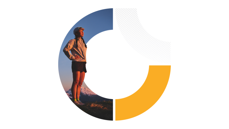 A female runner stands confidently at a mountain summit as the sun rises