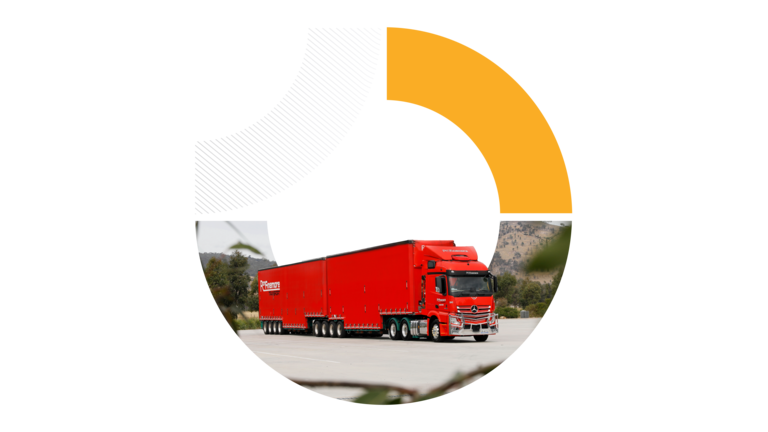 A circular graphic cropped into a semicircle, showing a red semi-trailer truck parked on an asphalt road under a bright sky.