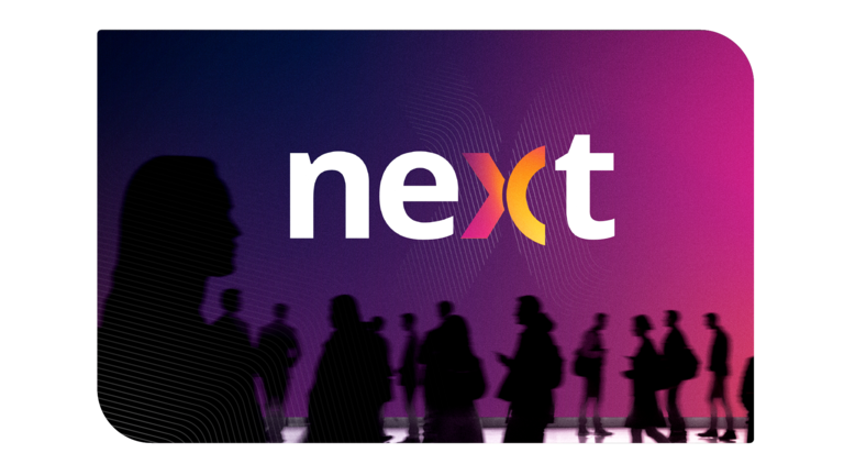Trimble NEXT event visual with attendees networking in front of a colorful NEXT conference backdrop