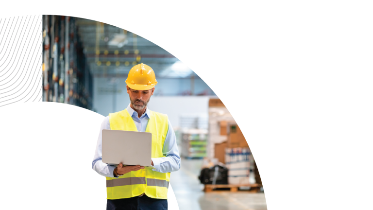 Man with a laptop in a warehouse