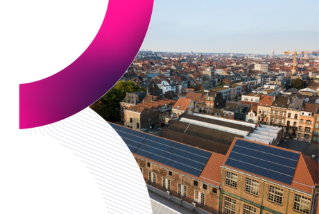 An aerial view of the Brussels cityscape featuring industrial brick buildings with rooftop solar panels in the foreground and the city skyline in the distance, framed by a stylized pink and grey graphic curve, representing the host city for Trimble Insight Europe 2026 hotel and travel accommodation.
