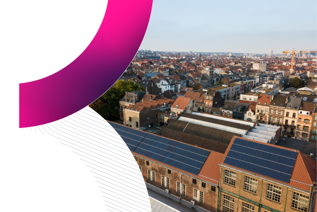 An aerial view of the Brussels cityscape featuring industrial brick buildings with rooftop solar panels in the foreground and the city skyline in the distance, framed by a stylized pink and grey graphic curve, representing the host city for Trimble Insight Europe 2026 hotel and travel accommodation.